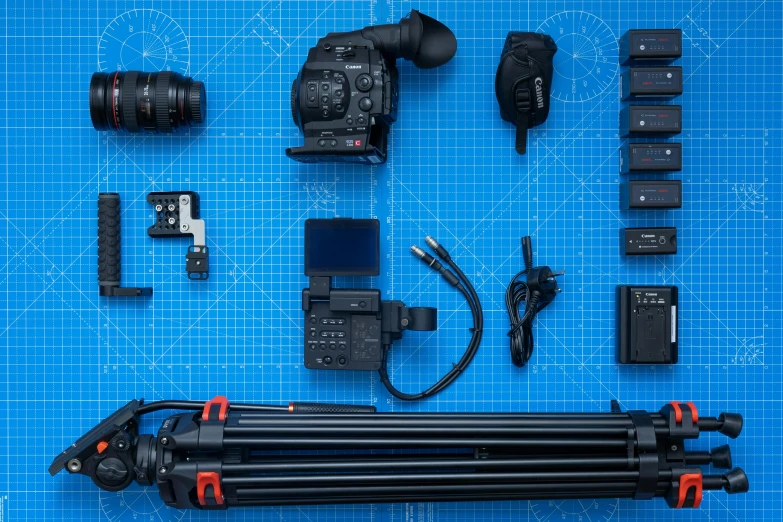 camera equipment including flash and batteries laying on a blue  mat