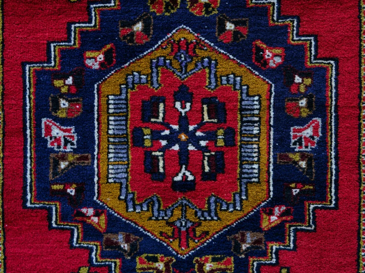 an intricately designed rug in red and yellow colors