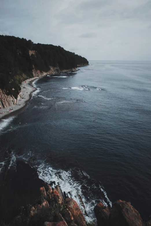 a body of water next to a lush green hillside