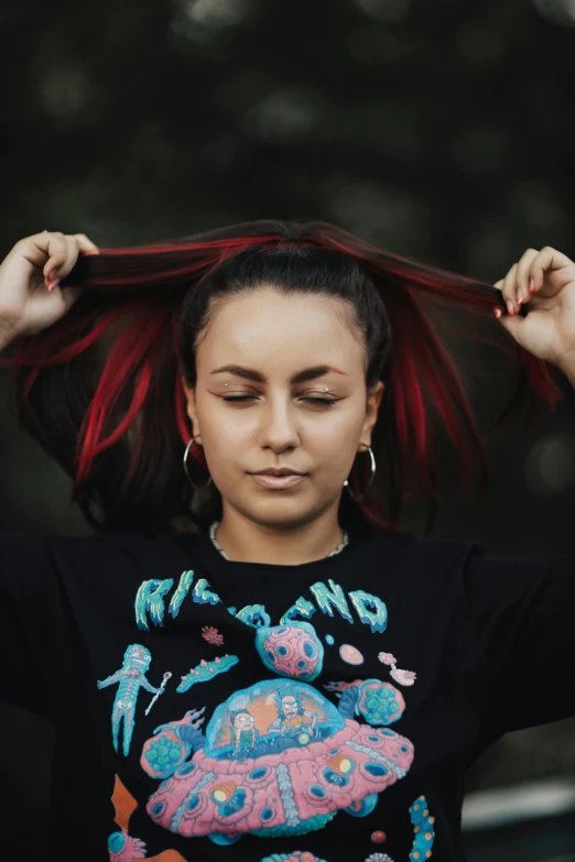 a person with some red hair standing by some trees