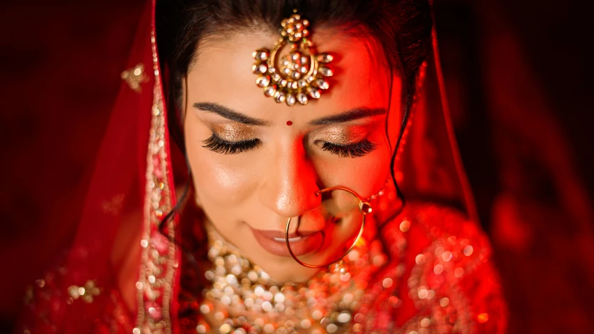 a bride posing for a pograph wearing a veil and tiara