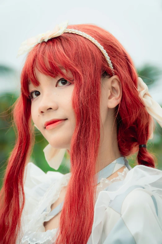 girl with red hair wearing a white shirt