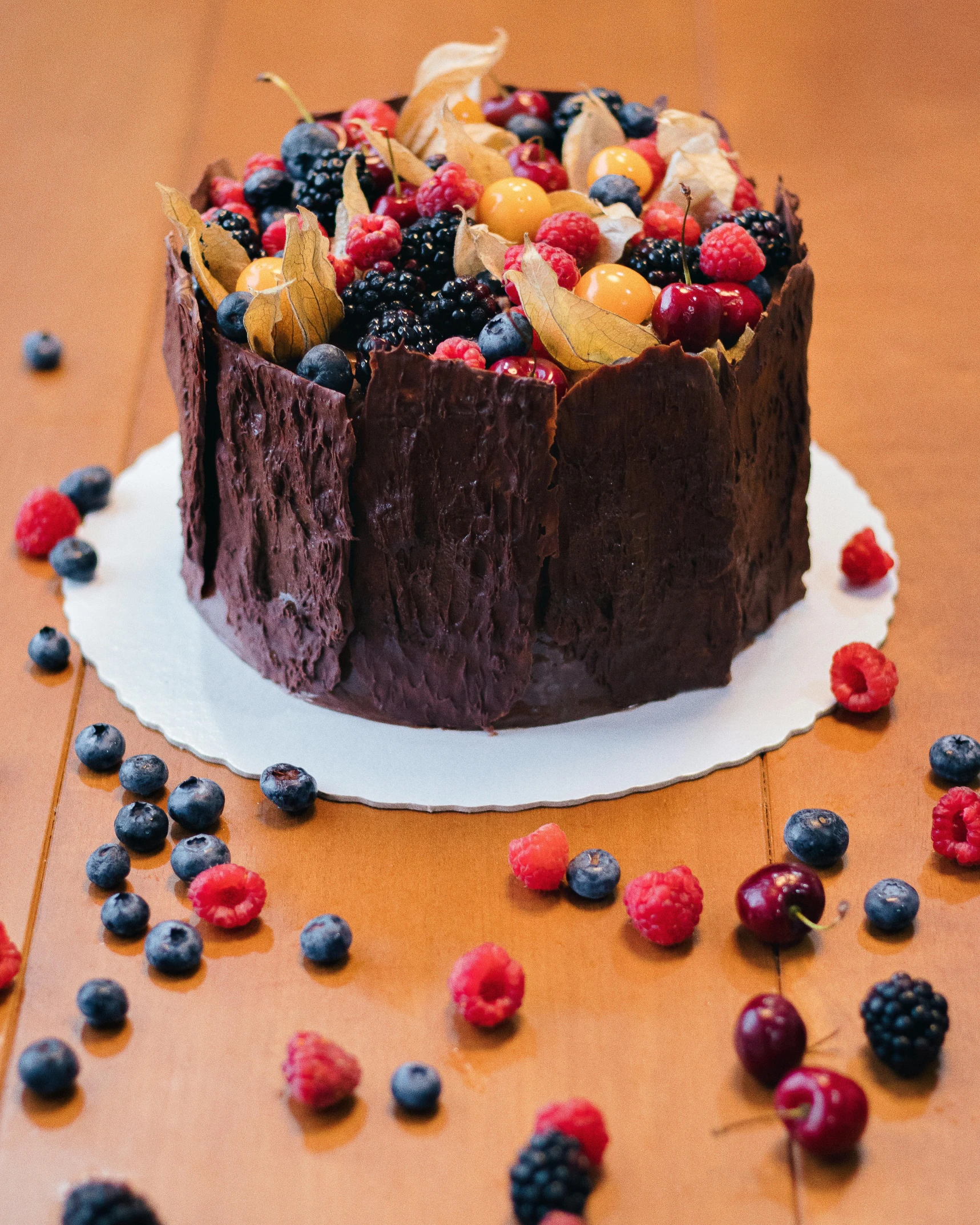 a cake that is on a plate with berries