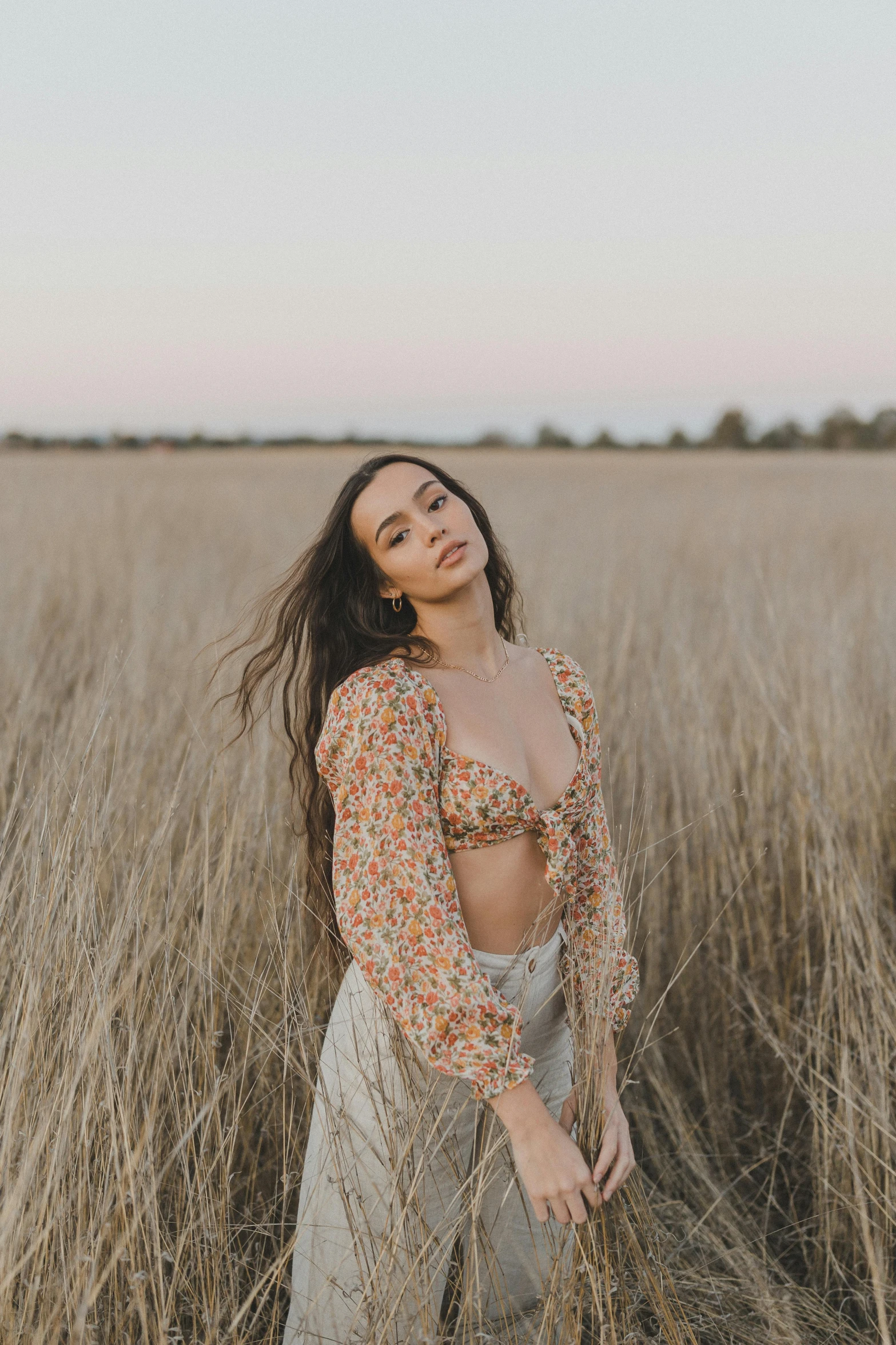 woman standing in a field posing for the camera