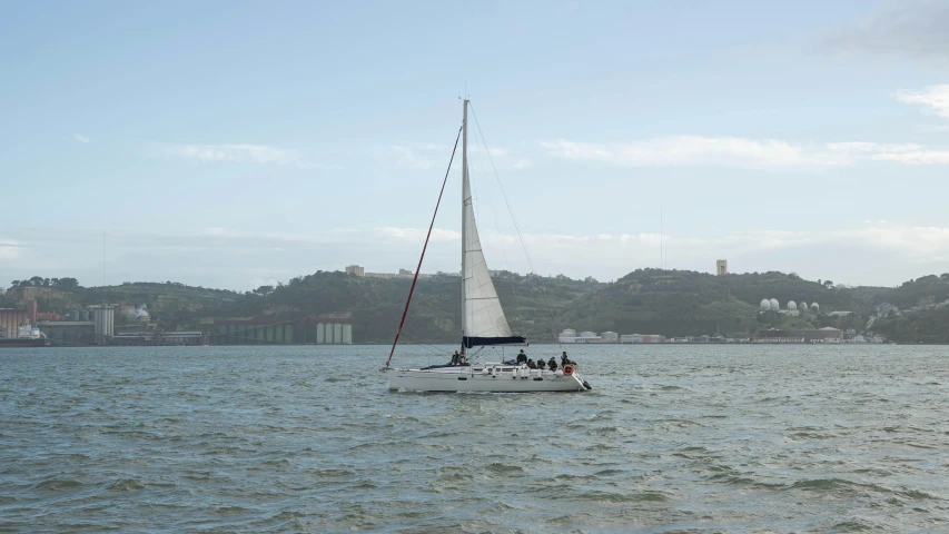 a sailboat in the ocean with people on it