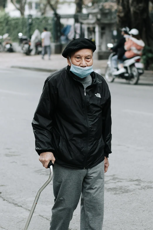 a man wearing a face mask with a cane