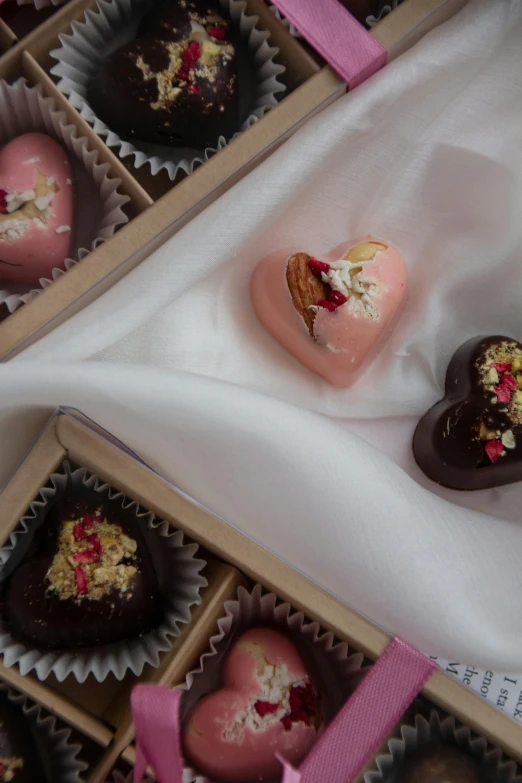 chocolate heart shaped cakes in boxes with pink ribbons