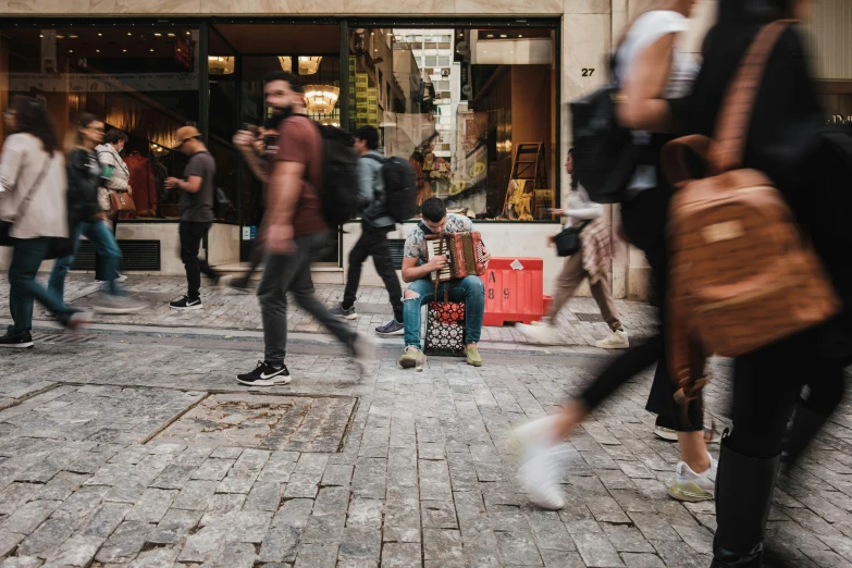 people are walking past shops and buildings