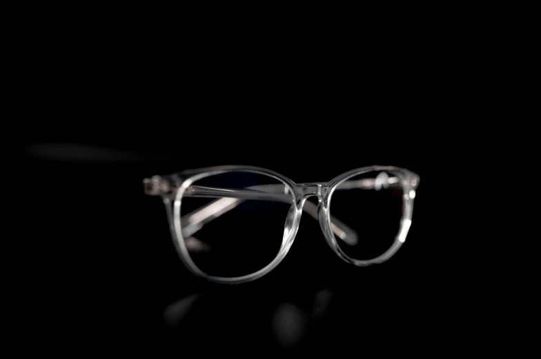 a pair of glasses is sitting on a black surface