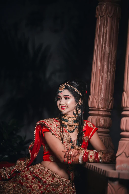 woman in ethnic dress sitting on bench at night