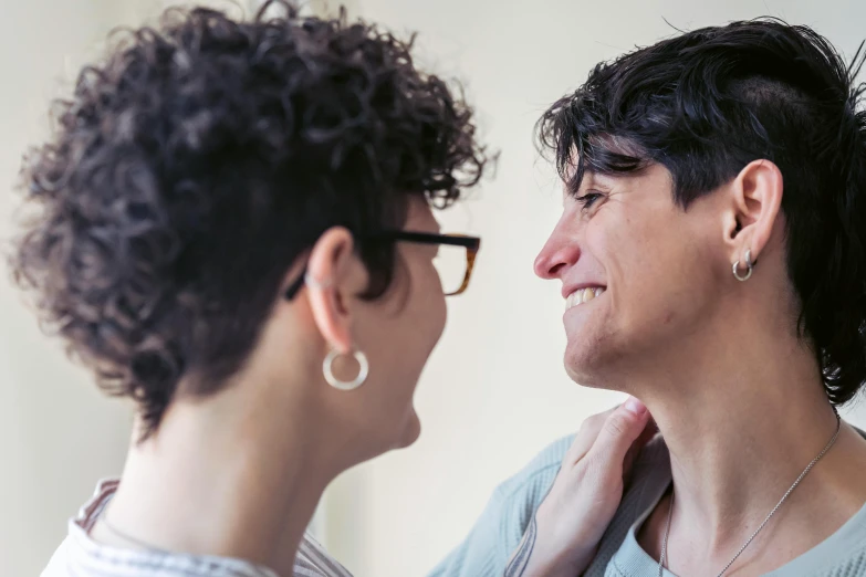 a woman standing next to another woman with glasses