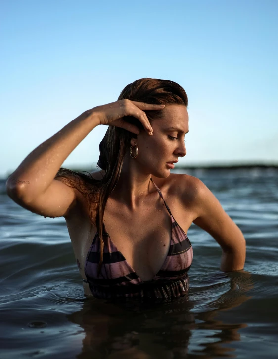 a woman wearing a bikini in the water