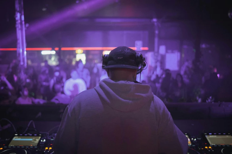 a dj spins around a crowded area while surrounded by people