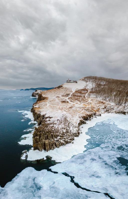 the view of an icy lake and small island