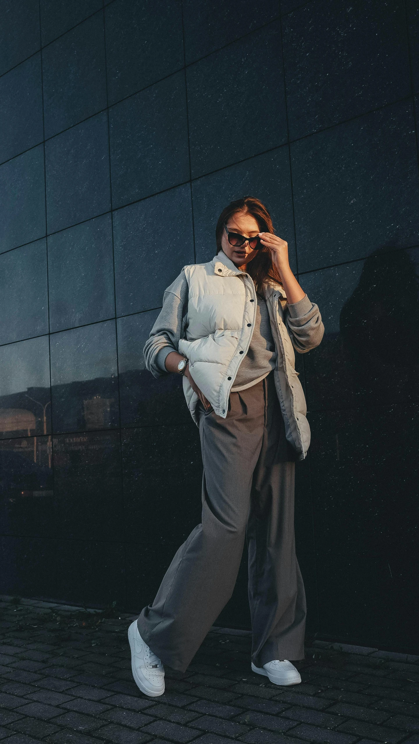 a woman is walking down the street in winter