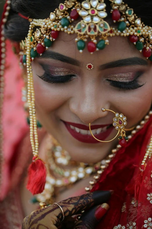 woman in indian bridal make up with accessories smiling