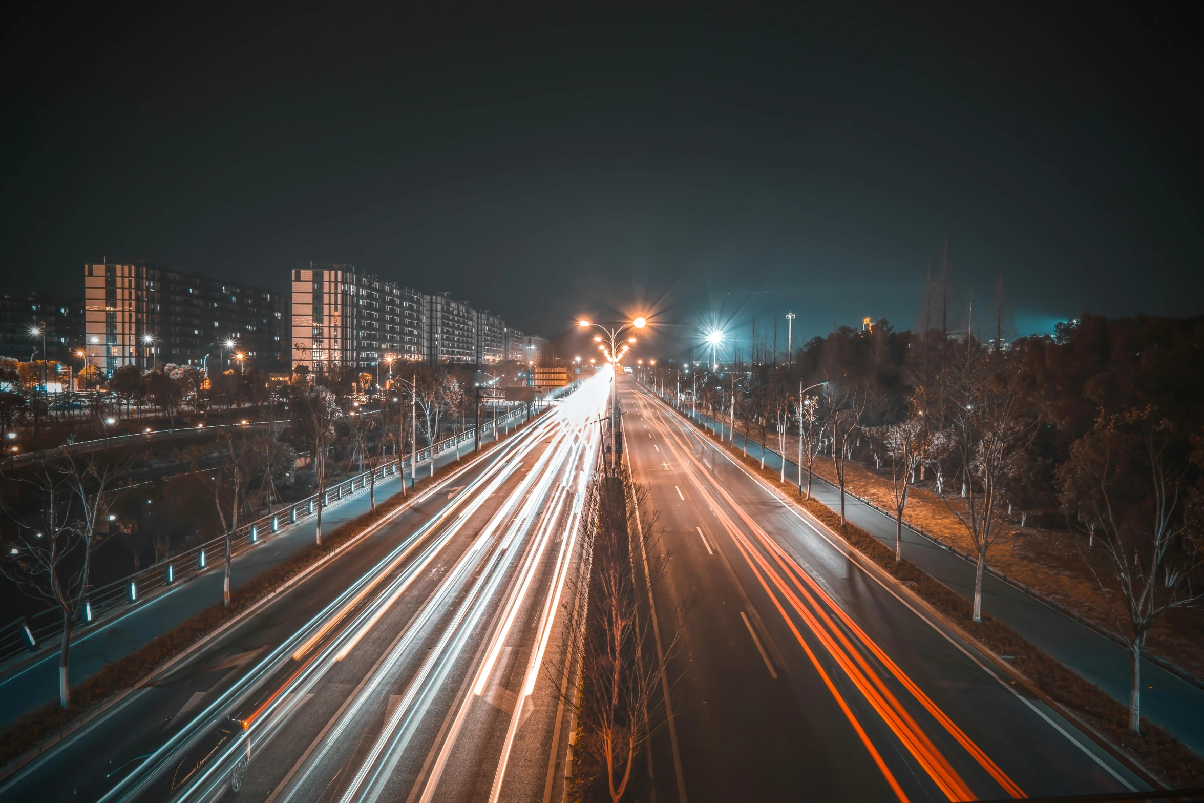 view of a busy highway with lights streaking down