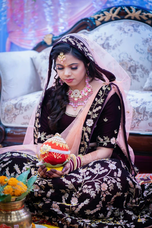 a bride with traditional jewelry and jewelry is sitting