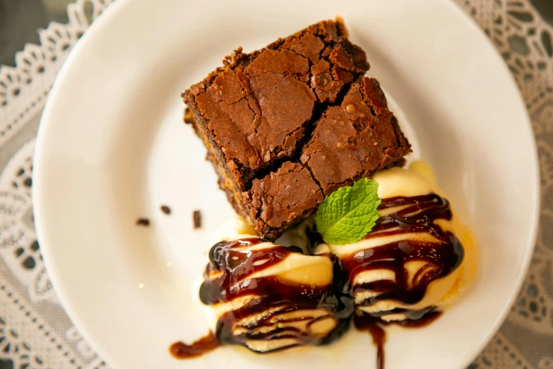 a plate with chocolate brownie and green garnishes
