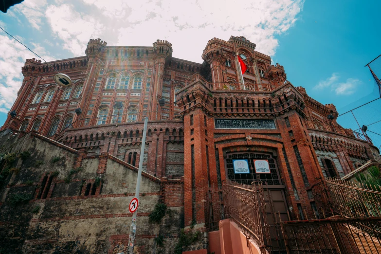 a large brown brick building with two tall clock towers