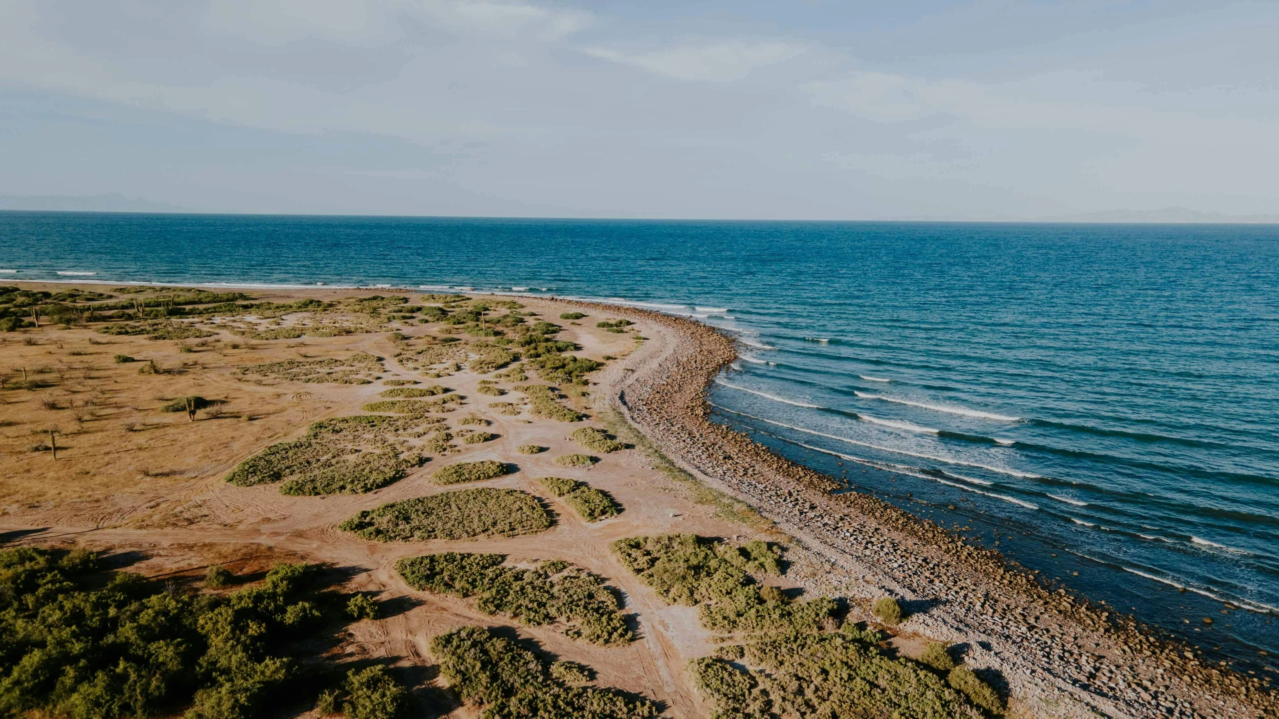 an aerial po of a beach with clear water