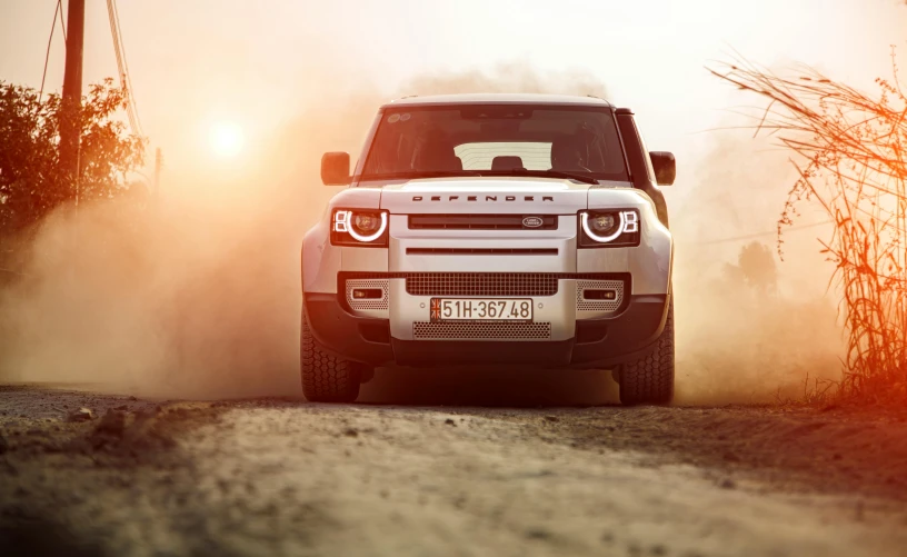 a range rover is parked in the middle of a dirt road