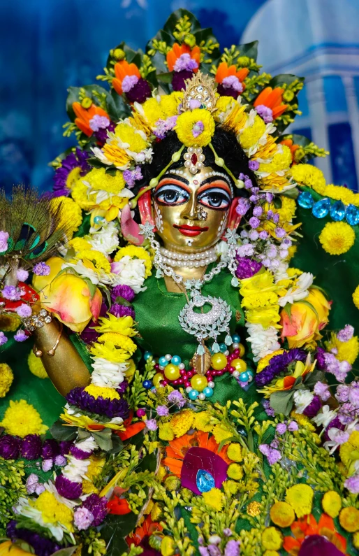 a god decorated with flowers is on display