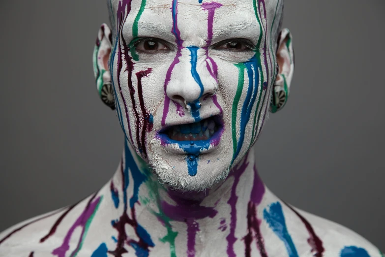 a man that is painted and has paint on his face