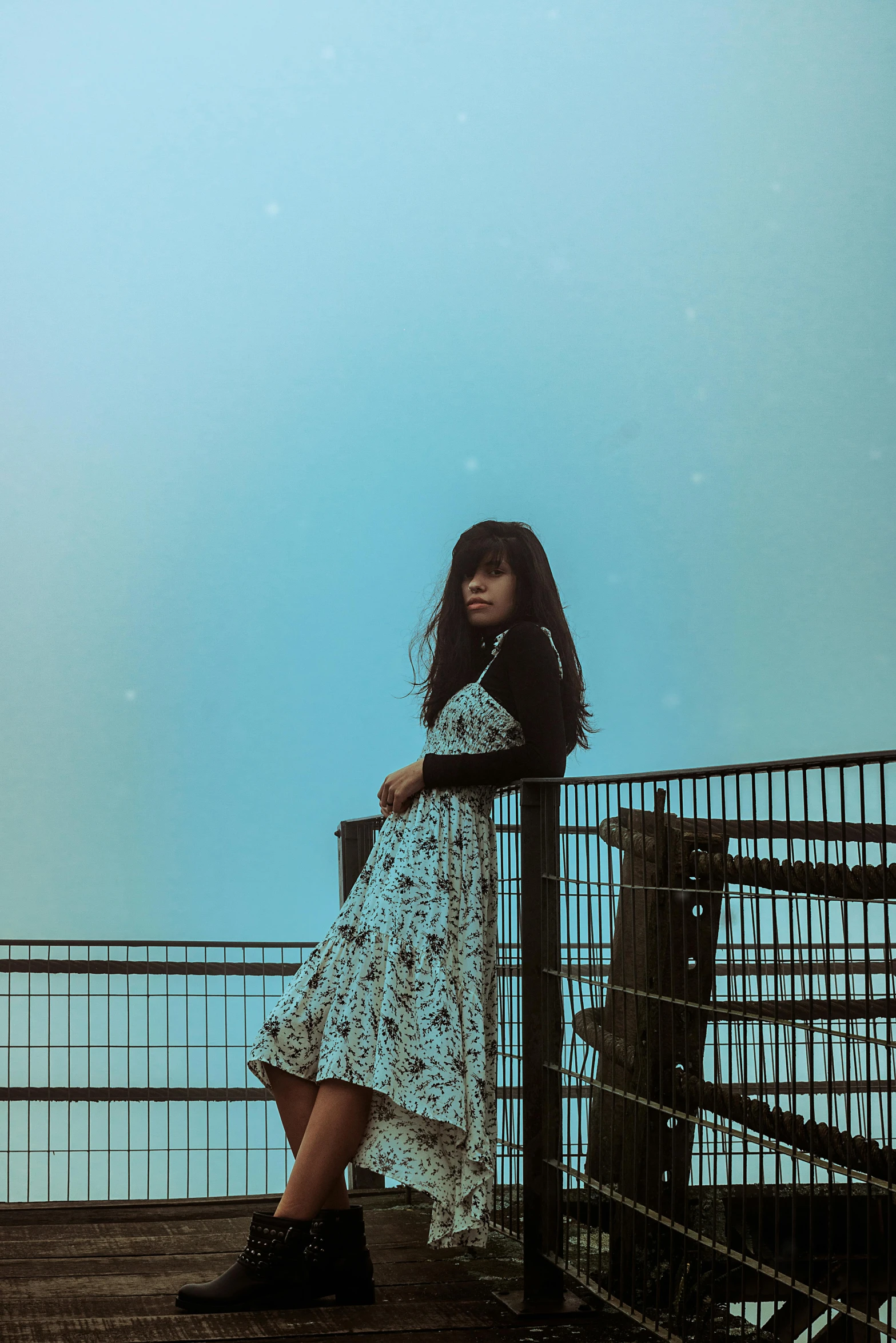 a woman with a long dress is posing on a stairway