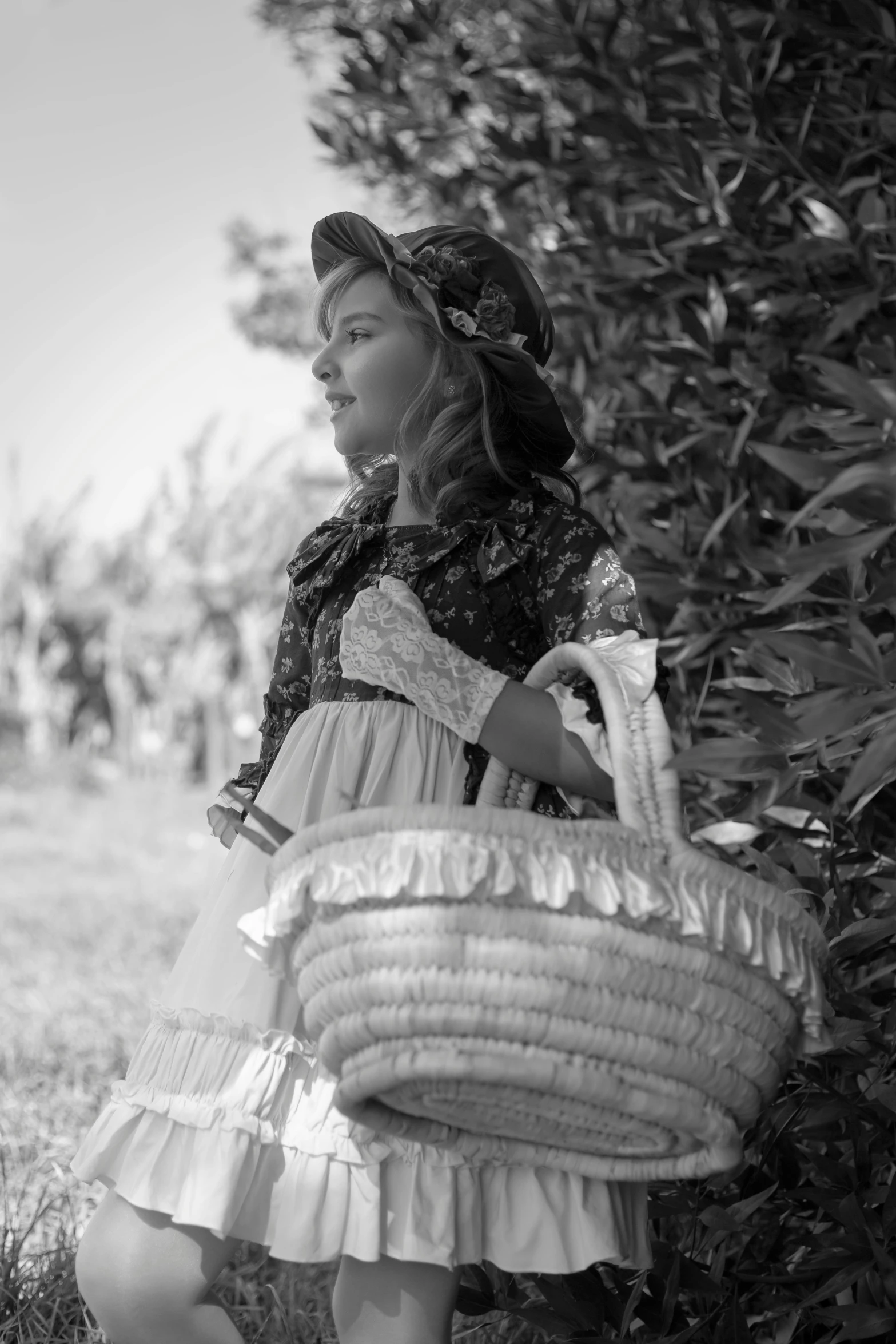 a small girl wearing a dress and holding a basket