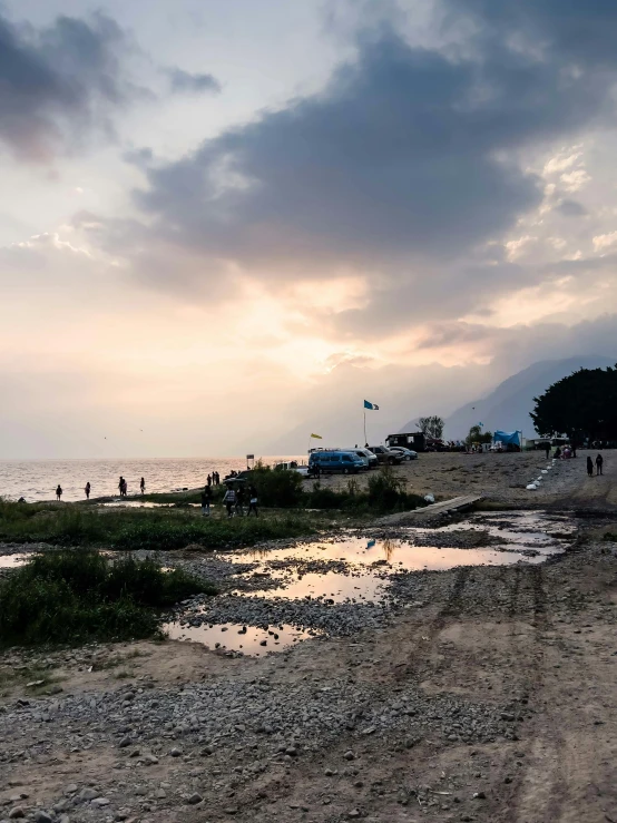 a beach area with several people and water