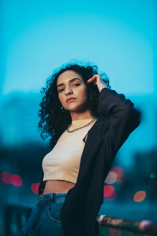 young adult woman standing on the edge of a bridge