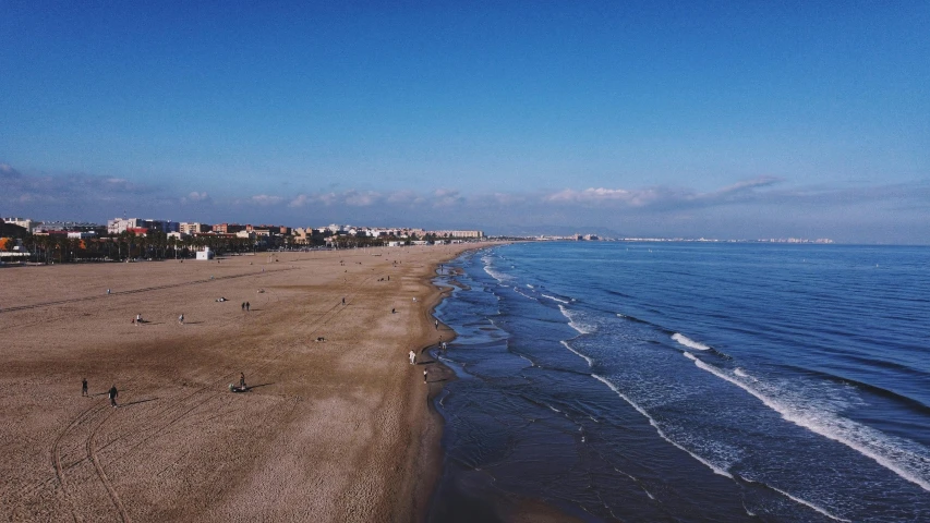 a view of a beach with buildings along the beach