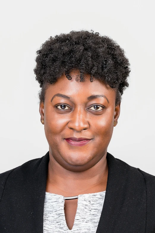 a woman in black blazer and white shirt with afro hair