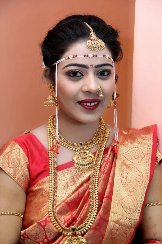 a woman with necklaces on her shoulders in a red dress