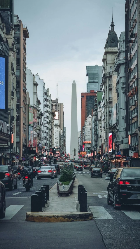 a street full of parked cars near tall buildings