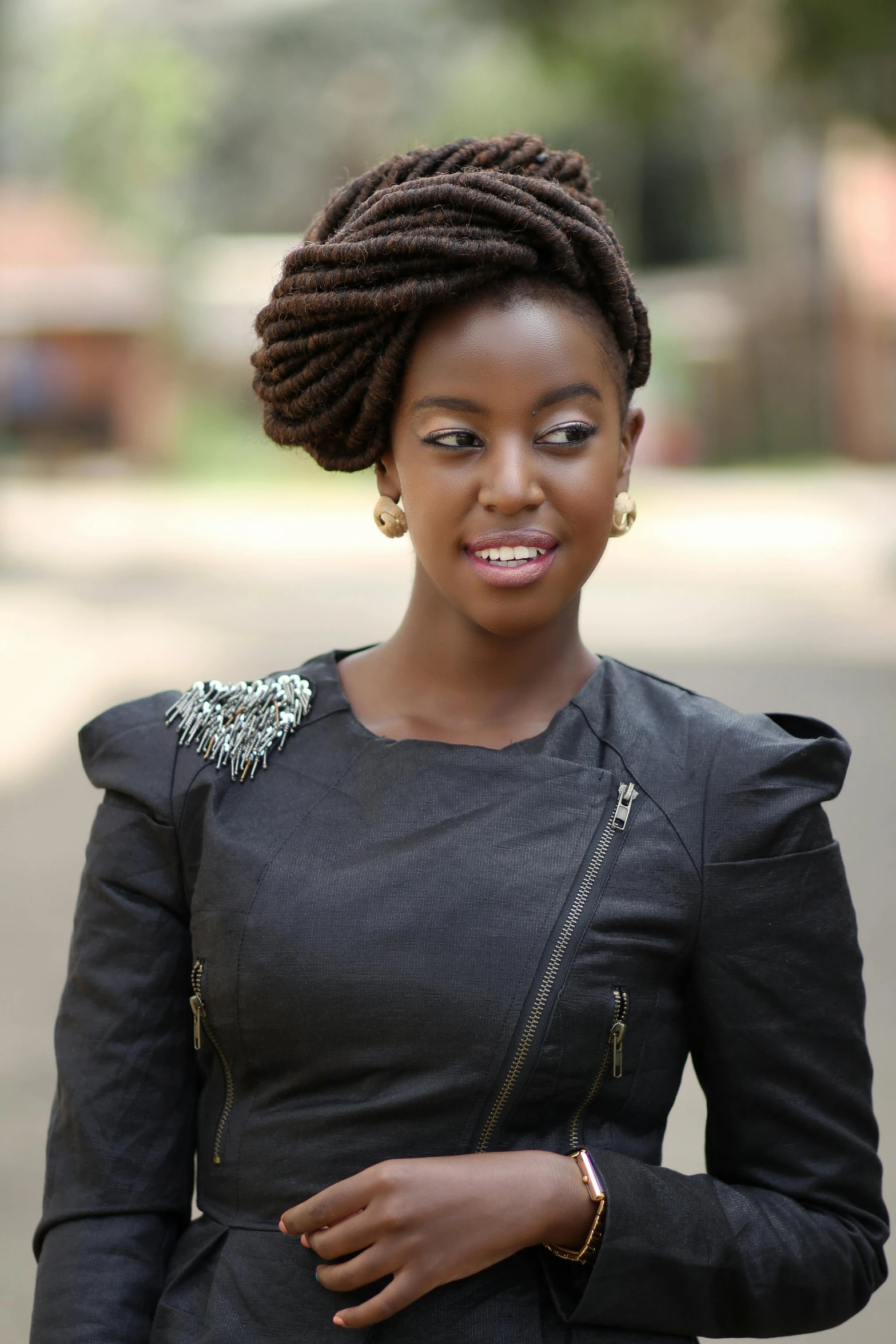 a woman with a id in a black dress smiling