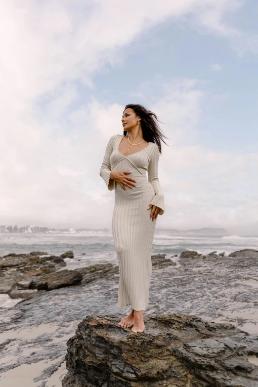 an image of a woman standing on the beach