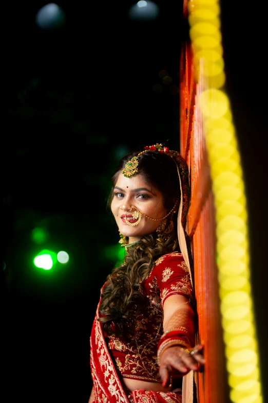 an indian bride looks out the window at a wedding