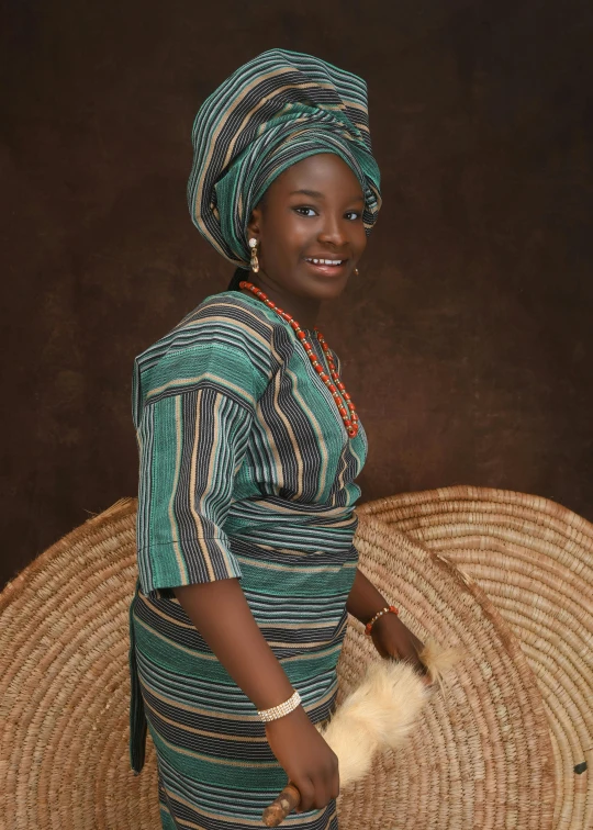 woman dressed in african attire posing for pograph