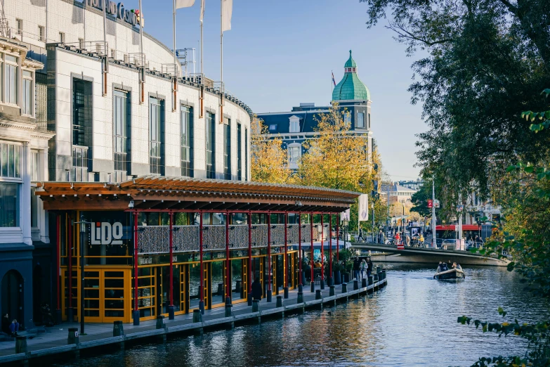 a long boat on the water is near buildings