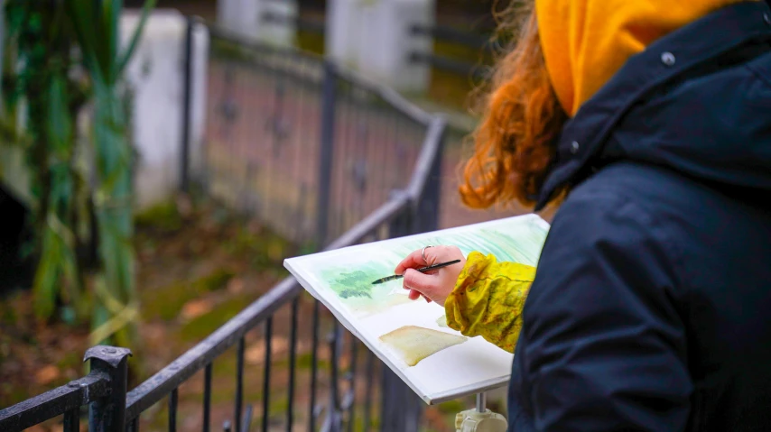 woman with her face drawn by a small piece of paper