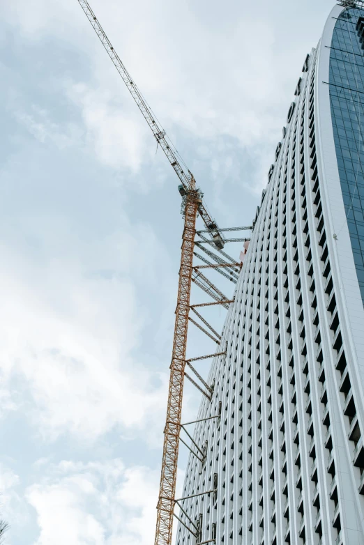 a crane is parked outside of the high rise building