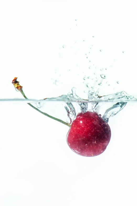 an apple is submerged in water on the table