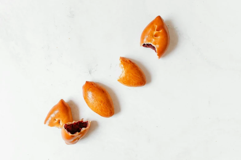 three pieces of orange fruit sit next to each other