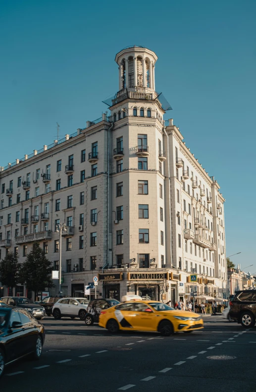 cars and taxis in front of a very large building