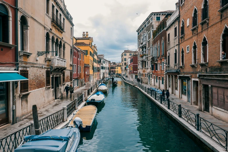 a city street lined with buildings and boats