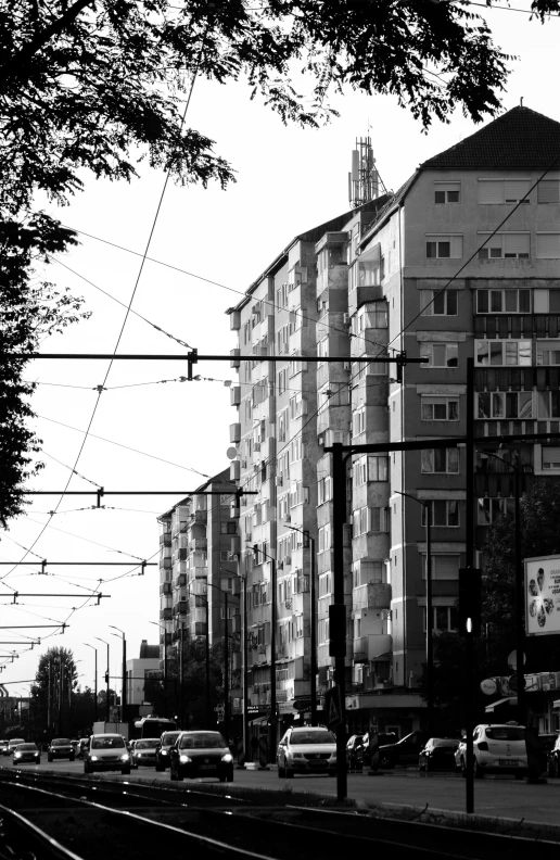 black and white po of train tracks and a building