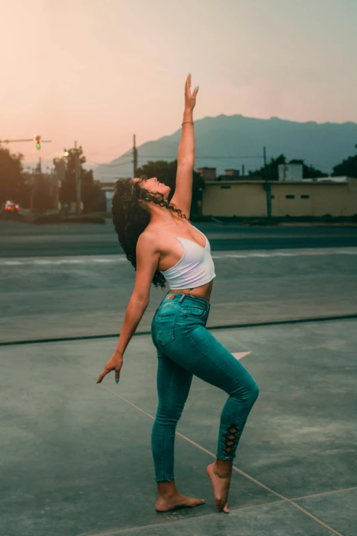 a woman in white top and green pants on the street