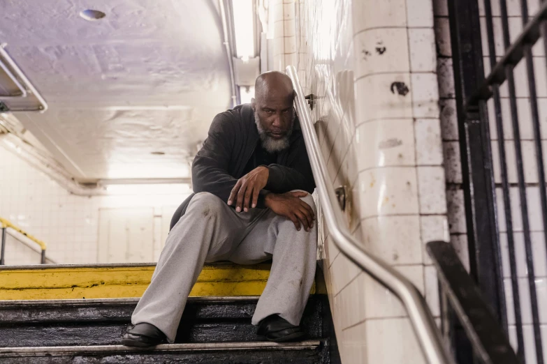 a man is sitting on a set of stairs